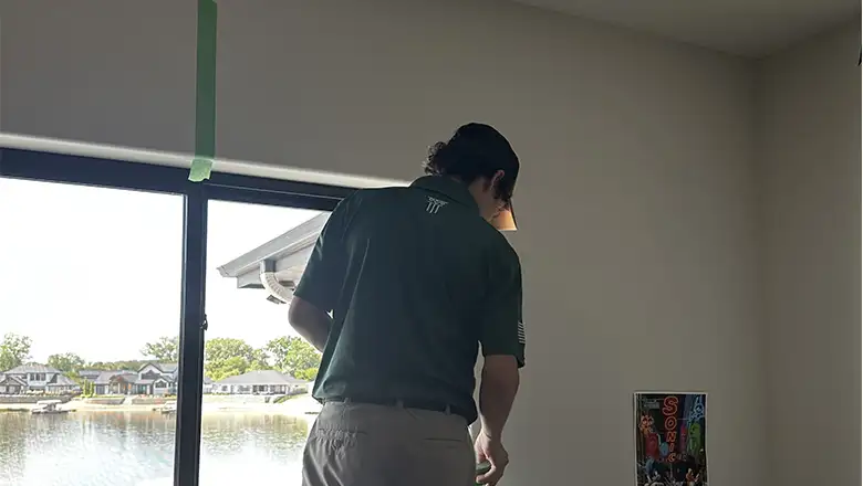 Skilled handyman performing drywall repair, creating a clean surface ready for paint